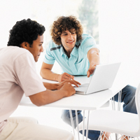 Two students looking at laptop
